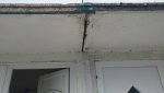 Penetrating damp / stain on joining wall just below porch roof