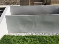 Bumps appeared in rendered retaining garden planter wall.