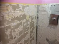Plastering over old tile adhesive in bathroom