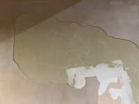 Green and yellow paint under old wallpaper