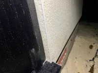 Damp on inside and outside following rain, recently rendered.
